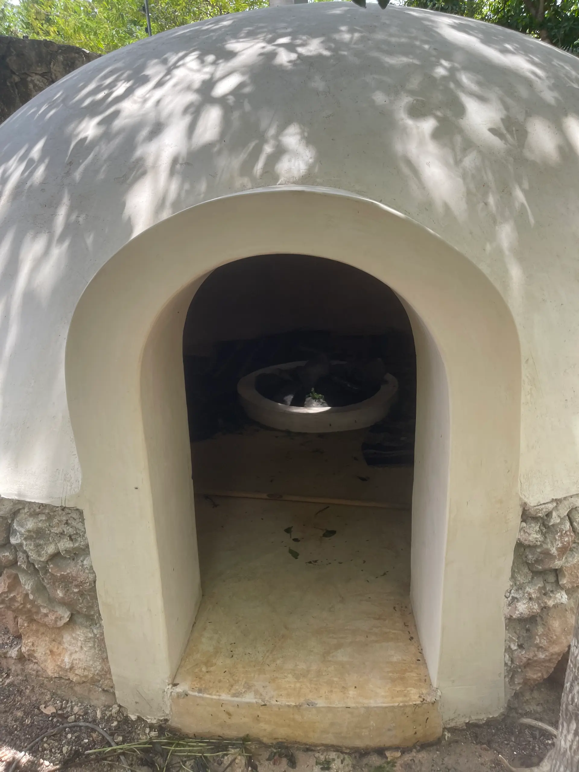 Entrada de un temazcal de mampostería terminado, con su arco blanco